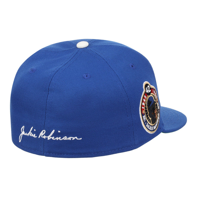 The EFF Jackie Robinson Signature Series Fitted Ballcap in royal features a white Jackie Robinson signature embroidered on the side, a Brooklyn Dodgers patch, and “42” on the back—a must-have for any collection.