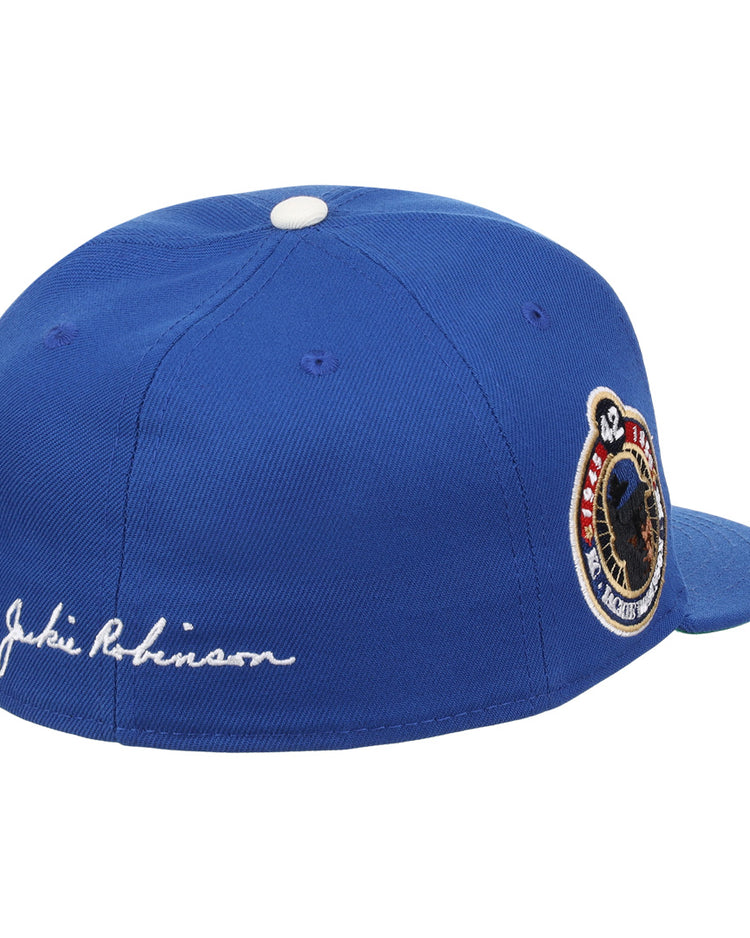 The EFF Jackie Robinson Signature Series Fitted Ballcap in royal features a white Jackie Robinson signature embroidered on the side, a Brooklyn Dodgers patch, and “42” on the back—a must-have for any collection.