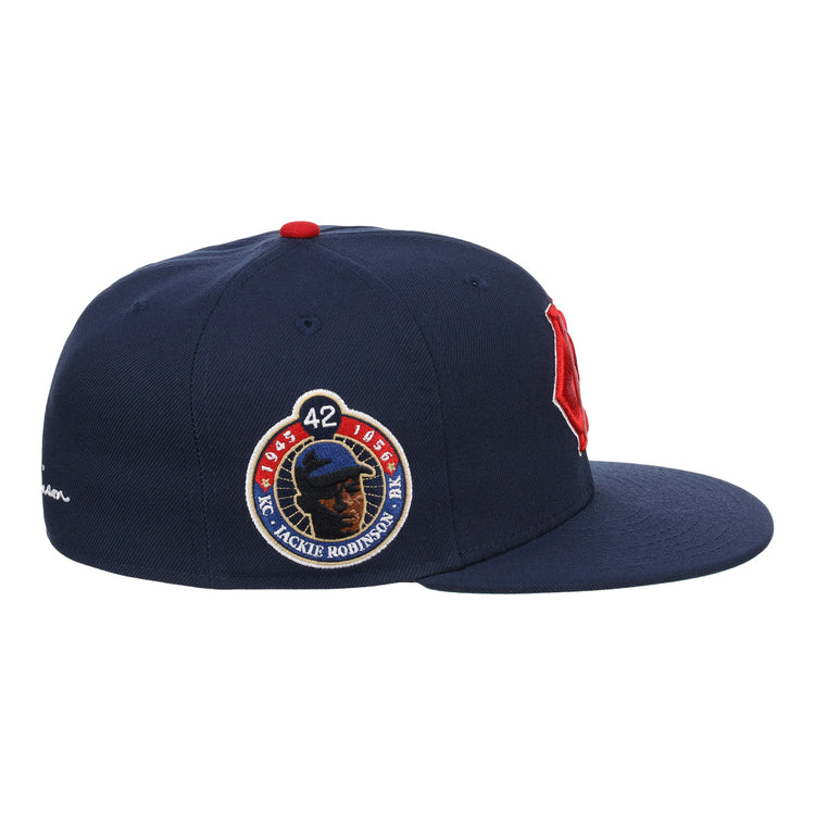 The EFF Kansas City Monarchs Robinson Fitted Ballcap in navy features a red B on the front, an embroidered KC logo, and a Jackie Robinson 50th anniversary patch with the number 42 on the side.