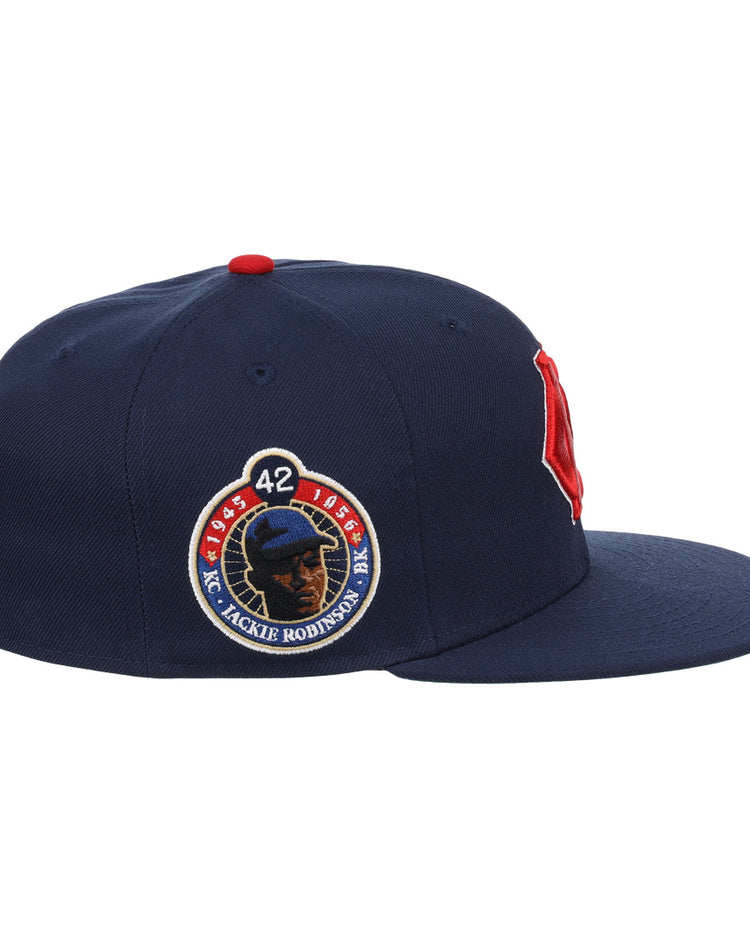 The EFF Kansas City Monarchs Robinson Fitted Ballcap in navy features a red B on the front, an embroidered KC logo, and a Jackie Robinson 50th anniversary patch with the number 42 on the side.