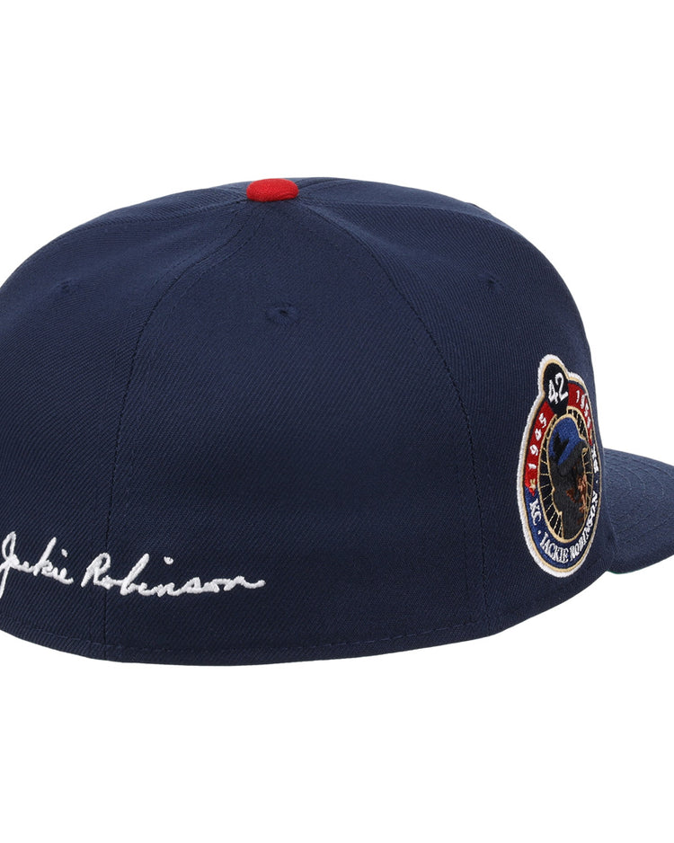 The EFF Kansas City Monarchs Robinson Fitted Ballcap in navy features a red top button, embroidered KC logo, 42 commemorative patch, and Jackie Robinson stitched in white script on the back.
