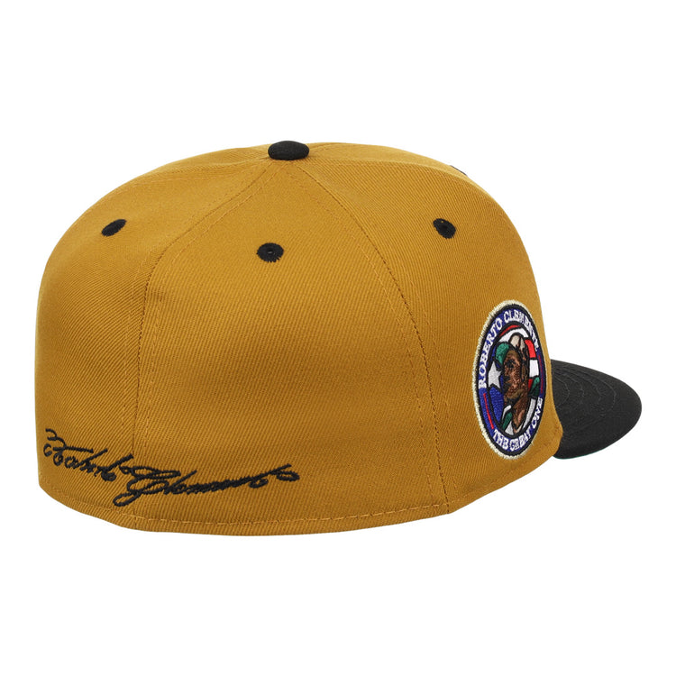 The EFF Roberto Clemente EFF Signature Series Fitted Ballcap in gold features a black brim, black top button, black ventilation eyelets, a round embroidered side patch, and cursive script on the back left panel.