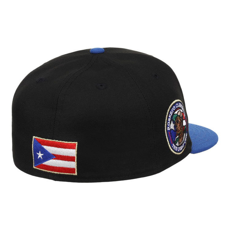 The EFF Santurce Cangrejeros Clemente Fitted Ballcap in black features a blue brim, Puerto Rican flag patch on the side, and a round embroidered patch near the back, celebrating Puerto Rican baseball legend Roberto Clemente.