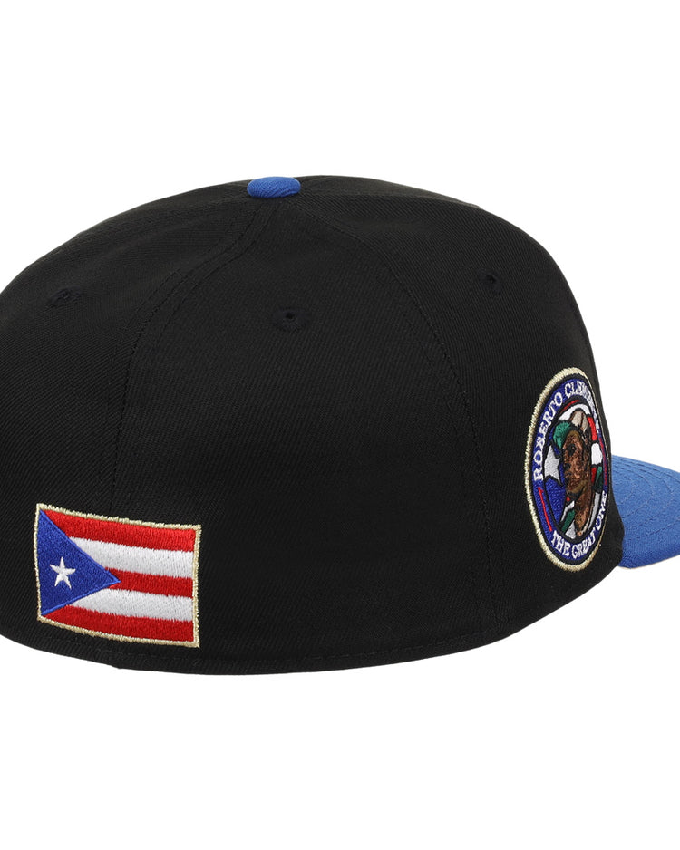 The EFF Santurce Cangrejeros Clemente Fitted Ballcap in black features a blue brim, Puerto Rican flag patch on the side, and a round embroidered patch near the back, celebrating Puerto Rican baseball legend Roberto Clemente.