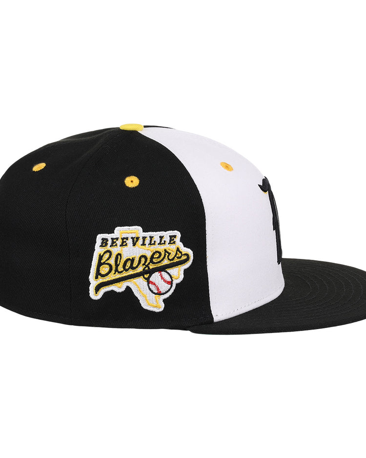 The Beeville Blazers EFF Lone Star Fitted Ballcap by EFF is a black and white flat-brim cap featuring an embroidered Beeville Blazers logo patch with a Texas outline and baseball graphic, representing the Lone Star League.