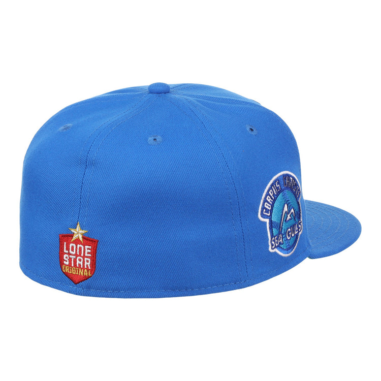 The Corpus Christi Seagulls EFF Lone Star Fitted Ballcap by EFF is blue with a round Seagulls patch on the side and a red Lone Star League Original patch featuring a gold star on the back left.