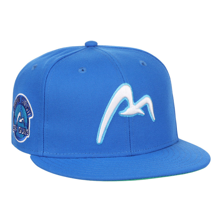 The EFF Corpus Christi Seagulls EFF Lone Star Fitted Ballcap is blue, with a white flying seagull on the front and a left-side patch reading Montgomery Biscuits Sea Gulls, inspired by the Lone Star League’s Corpus Christi Seagulls.