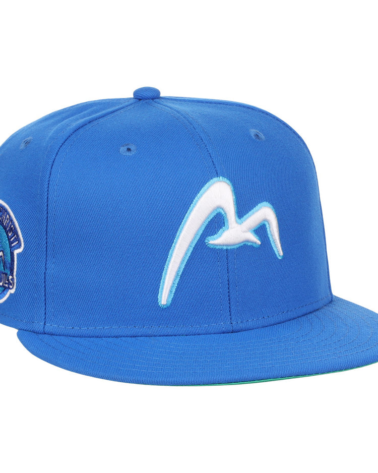 The EFF Corpus Christi Seagulls EFF Lone Star Fitted Ballcap is blue, with a white flying seagull on the front and a left-side patch reading Montgomery Biscuits Sea Gulls, inspired by the Lone Star League’s Corpus Christi Seagulls.