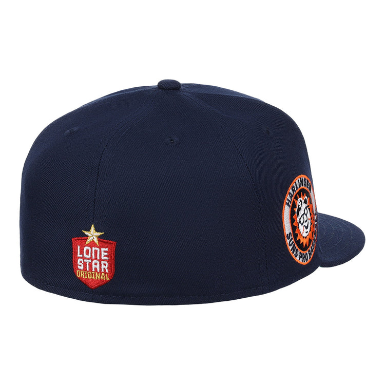 The Harlingen Suns EFF Lone Star Fitted Ballcap by EFF is navy blue with a round orange and white side patch, a Lone Star Original red badge on the back, and a button on top. The front of this cap isn’t shown.