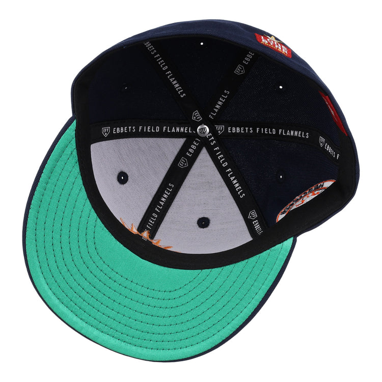 The Harlingen Suns EFF Lone Star Fitted Ballcap by EFF is navy blue, shown inside-out with a green underbrim, black sweatband, white Ebbets Field Flannels branded lining, stitched panels, and vent holes for an authentic Lone Star League look.