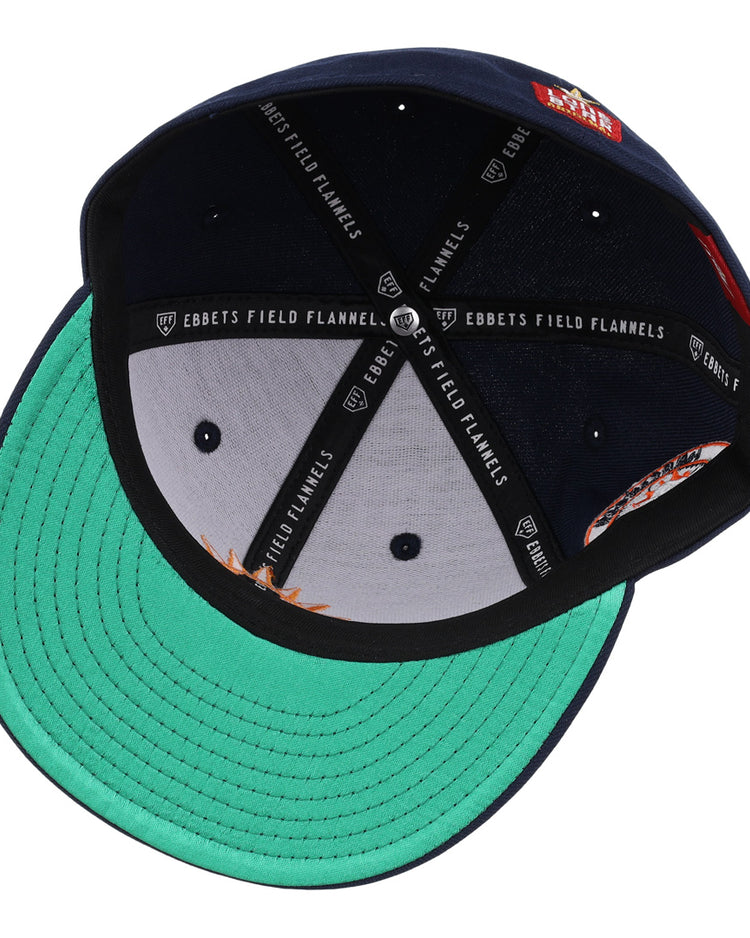 The Harlingen Suns EFF Lone Star Fitted Ballcap by EFF is navy blue, shown inside-out with a green underbrim, black sweatband, white Ebbets Field Flannels branded lining, stitched panels, and vent holes for an authentic Lone Star League look.