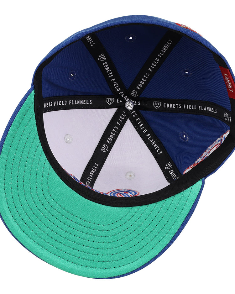The McAllen Dusters EFF Lone Star Fitted Ballcap by EFF features a green underbrim, blue crown, black and white Ebbets Field Flannels inner piping, silver rivets, and detailed stitching—honoring the Lone Star League’s McAllen Dusters.