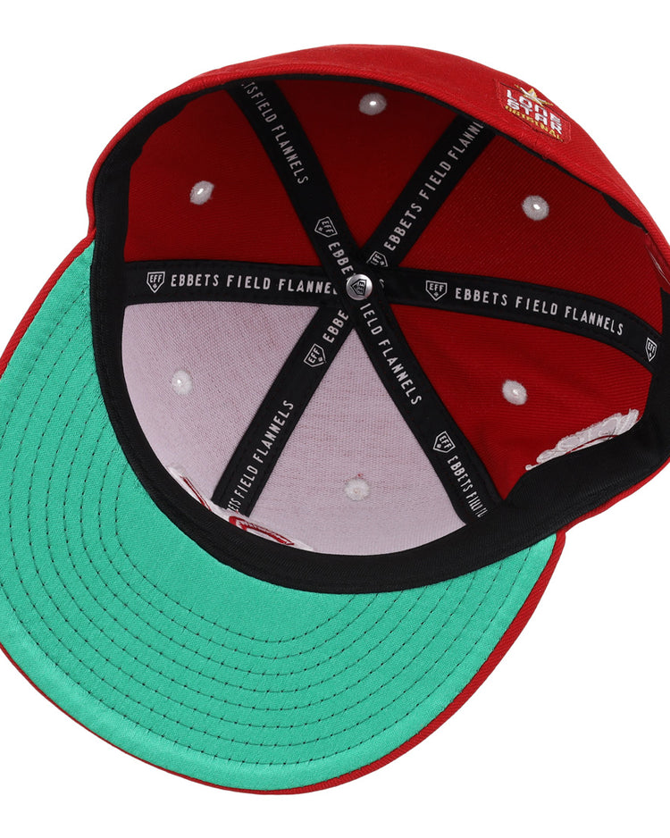 The underside of the Victoria Rosebuds EFF Lone Star Fitted Ballcap by EFF features a green brim, black EBBETS FIELD FLANNELS interior bands, white stitching, and a white button at the structured crown’s top center.