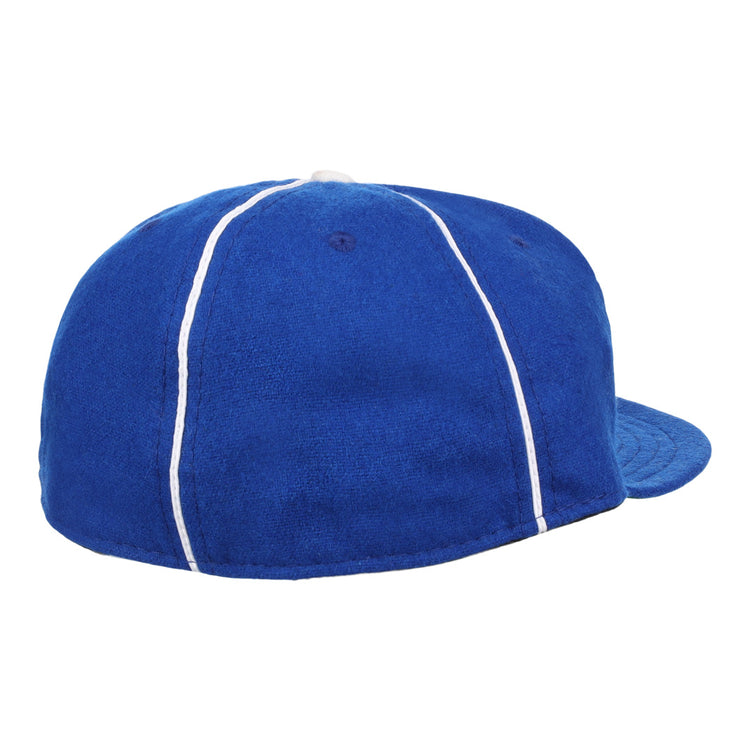 The Almendares Alacranes 1931 Vintage Ballcap by Ebbets Field Flannels is a blue wool hat with white piping, seen from the back and side, featuring a rounded crown and curved brim.
