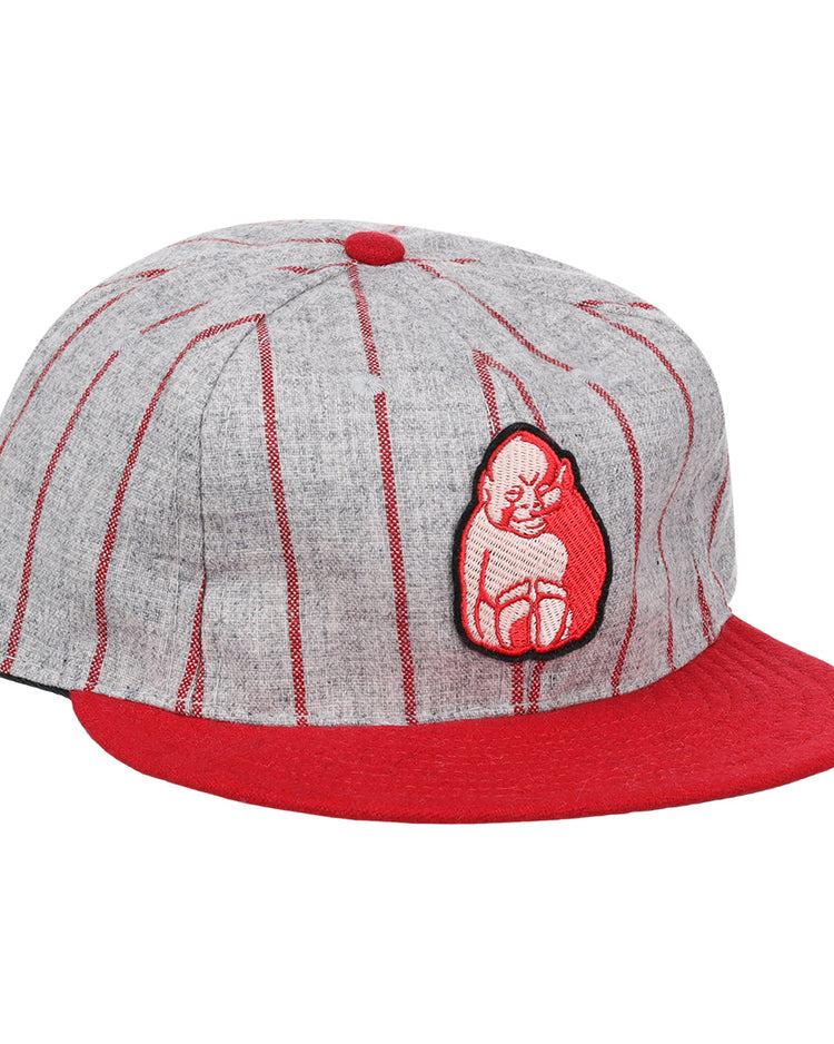 The Bilikens Cigarros 1921 Vintage Ballcap by Ebbets Field Flannels features thin red stripes, a red brim and button, plus a red-and-white cat patch inspired by classic Cuban Amateur League style.