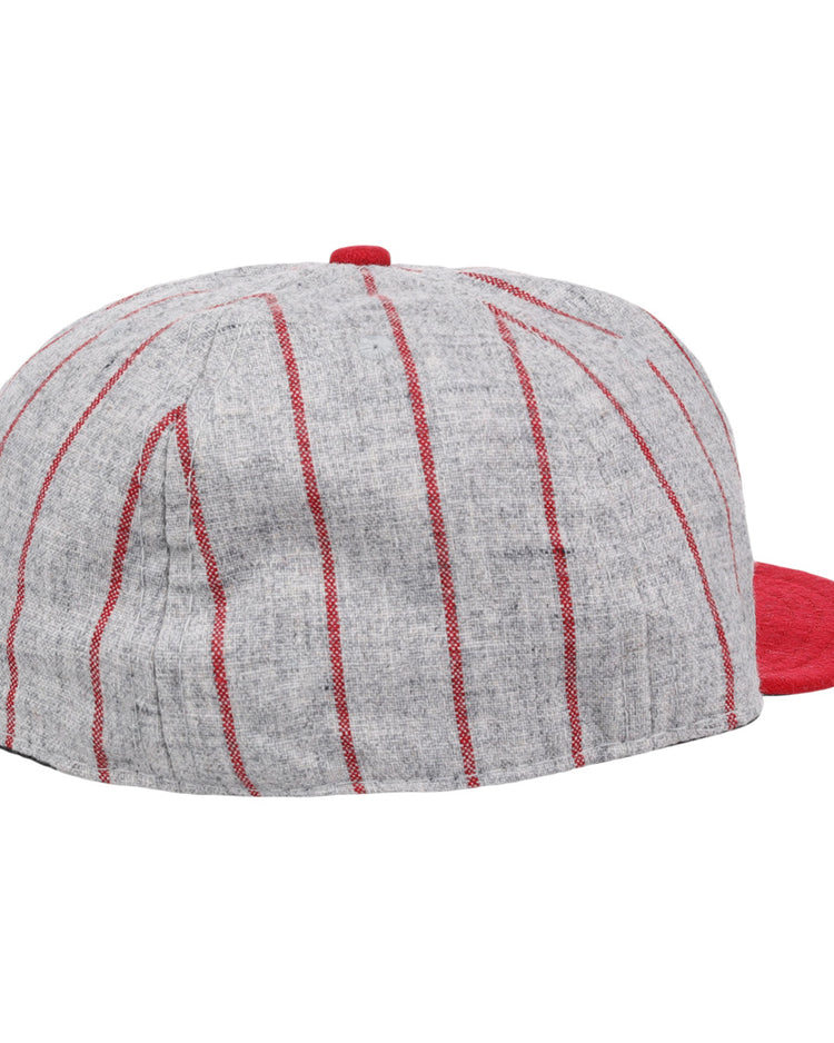 The Ebbets Field Flannels Bilikens Cigarros 1921 Vintage Ballcap features vertical red stripes and a solid red brim, inspired by the classic Cuban Amateur League design, shown from the back and slightly to the side.