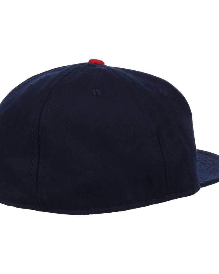 The Carta Blanca 1939 Vintage Ballcap by Ebbets Field Flannels is a navy blue cap with a red top button and panel stitching, inspired by classic Mexican League style and viewed from the back.