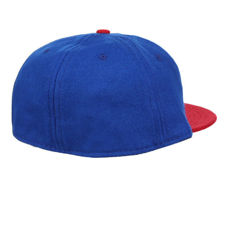 The Ebbets Field Flannels Miramar Yacht Club 1952 Vintage Ballcap features blue wool, a red brim and button, and is shown from the back/side on a white background—evoking classic yacht club styles.