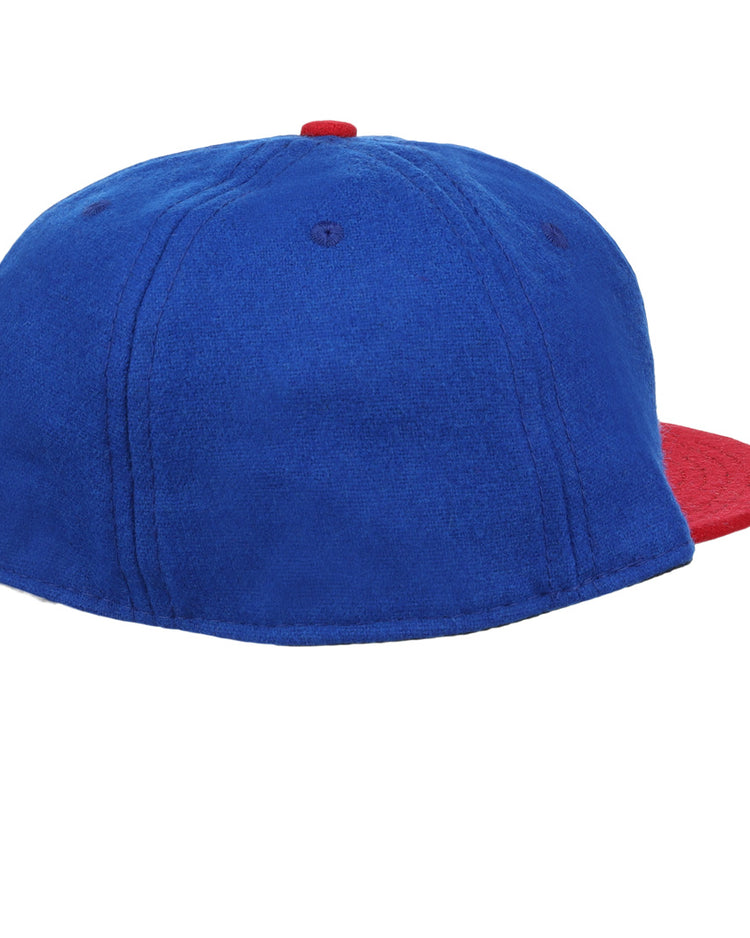 The Ebbets Field Flannels Miramar Yacht Club 1952 Vintage Ballcap features blue wool, a red brim and button, and is shown from the back/side on a white background—evoking classic yacht club styles.