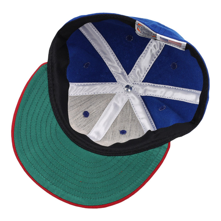 The underside of the Miramar Yacht Club 1952 Vintage Ballcap by Ebbets Field Flannels features a green brim, white stitched panels, ventilation holes, and an interior label—classic details of an authentic wool ballcap.