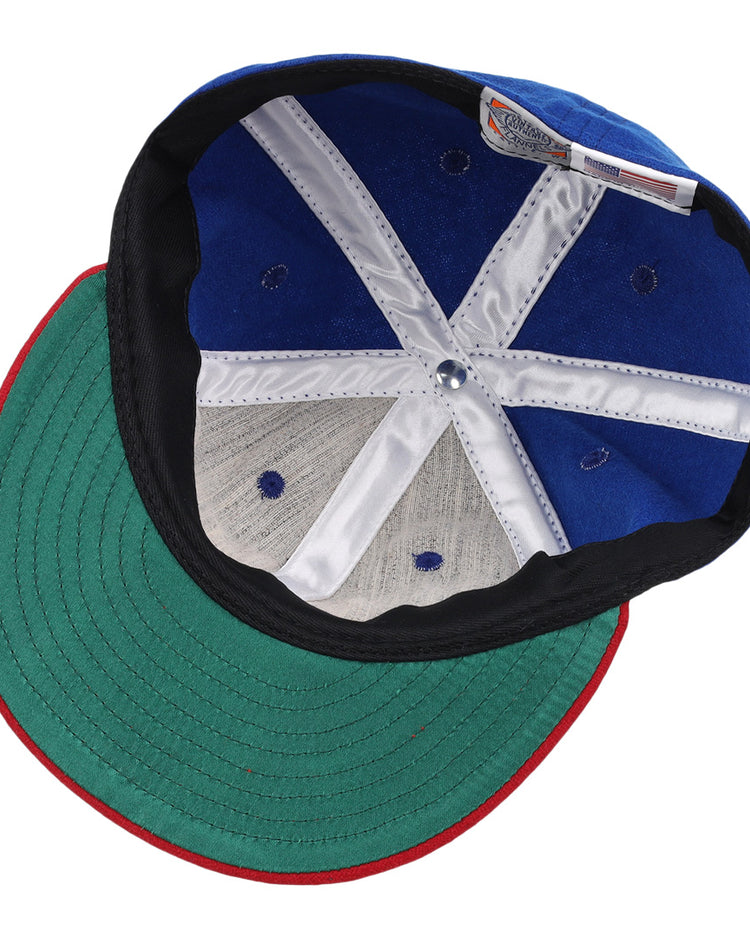 The underside of the Miramar Yacht Club 1952 Vintage Ballcap by Ebbets Field Flannels features a green brim, white stitched panels, ventilation holes, and an interior label—classic details of an authentic wool ballcap.