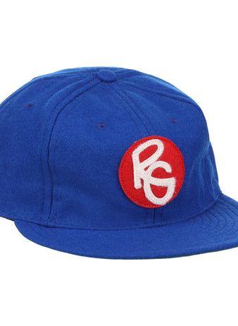 The EFF Seattle Royal Giants 1935 Vintage Ballcap is a blue wool hat with a red circular patch on the front, featuring stylized white PG letters—an authentic reproduction of the classic teams design.