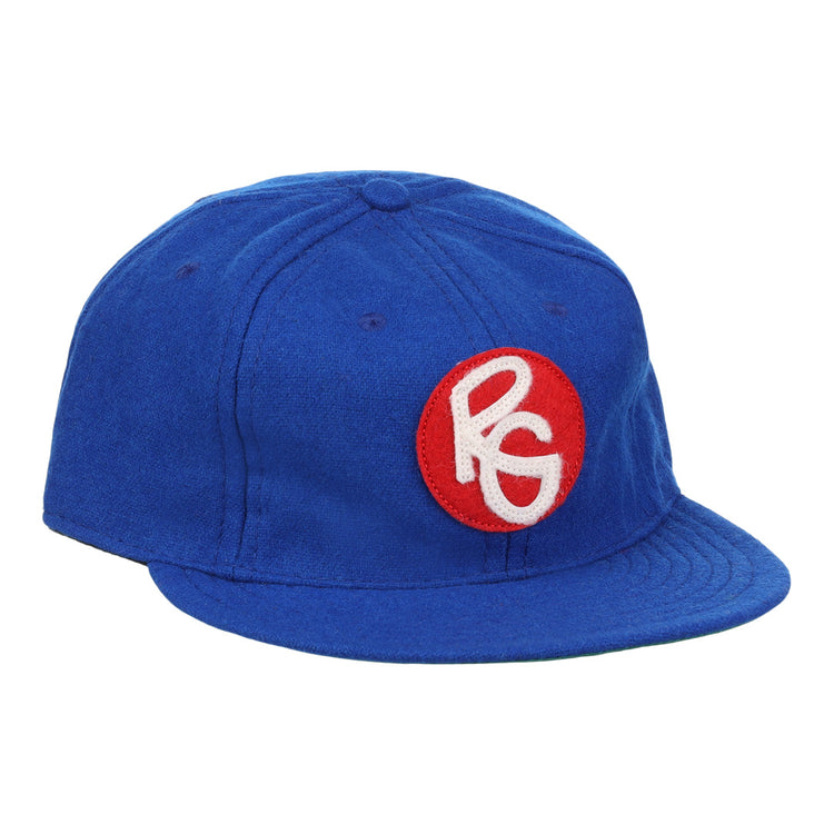 The EFF Seattle Royal Giants 1935 Vintage Ballcap is a blue wool hat with a red circular patch on the front, featuring stylized white PG letters—an authentic reproduction of the classic teams design.