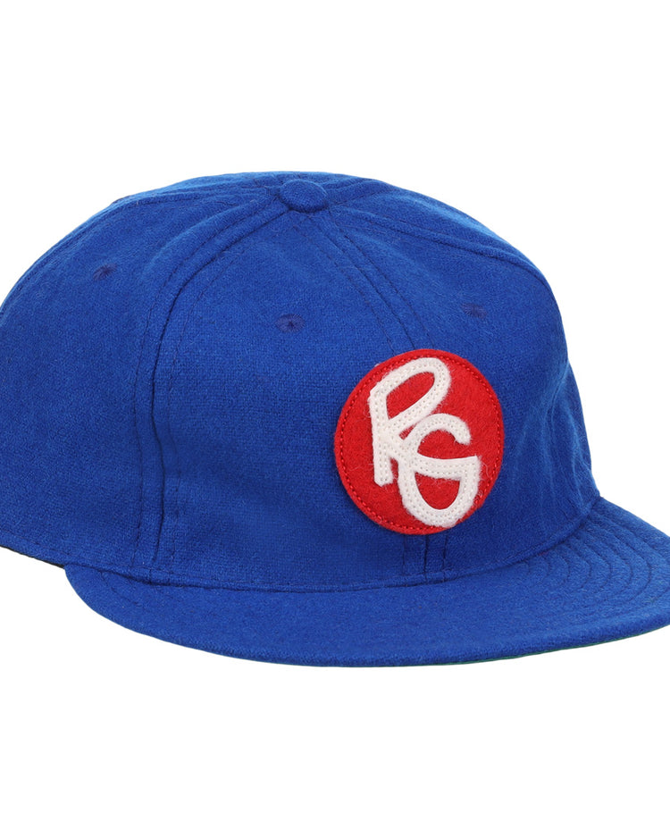 The EFF Seattle Royal Giants 1935 Vintage Ballcap is a blue wool hat with a red circular patch on the front, featuring stylized white PG letters—an authentic reproduction of the classic teams design.