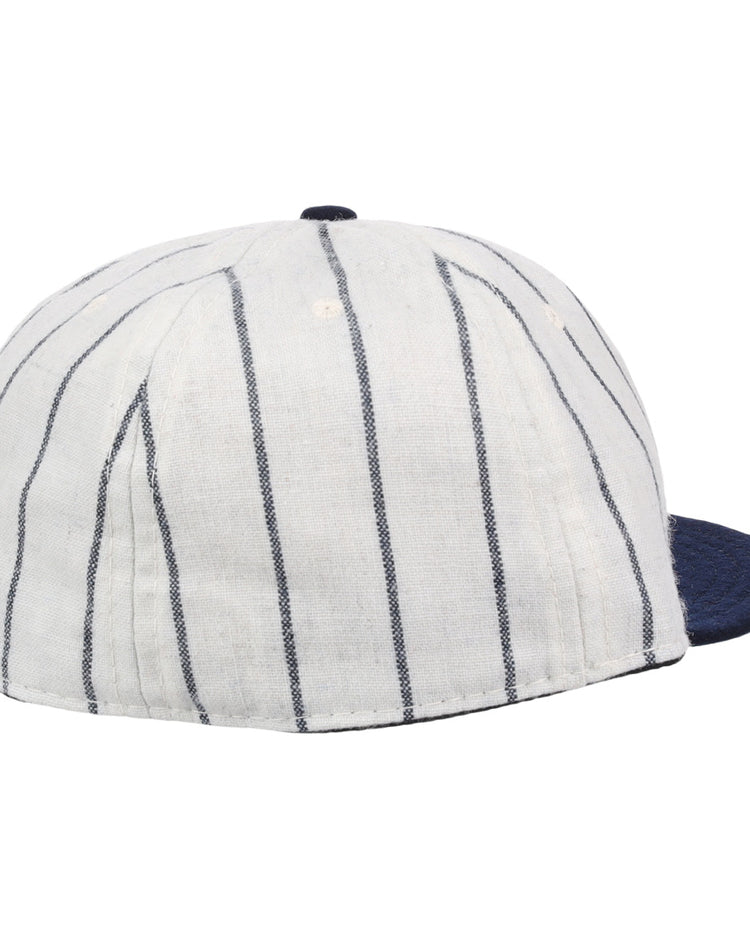 The Ebbets Field Flannels Vedado TC 1930 Vintage Ballcap features thin vertical navy stripes and a solid navy brim, inspired by the classic design, and is shown from back and side angles.