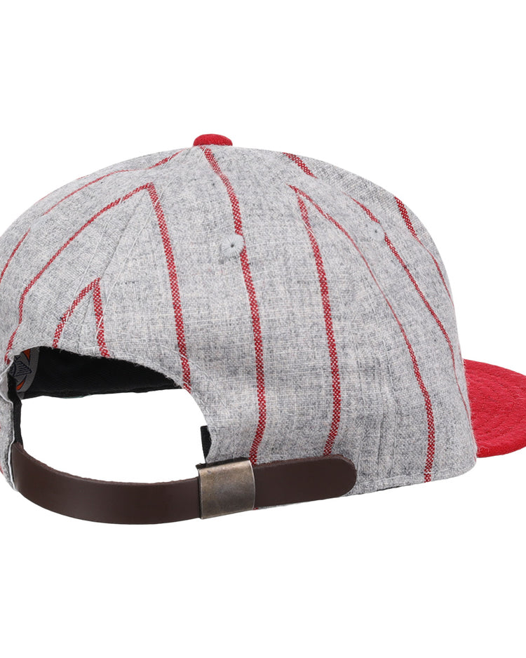 The Ebbets Field Flannels Bilikens Cigarros 1921 Vintage Ballcap features gray fabric, red stripes, a red brim, and an adjustable brown leather strap with metal buckle—evoking the classic Cuban Amateur League style.