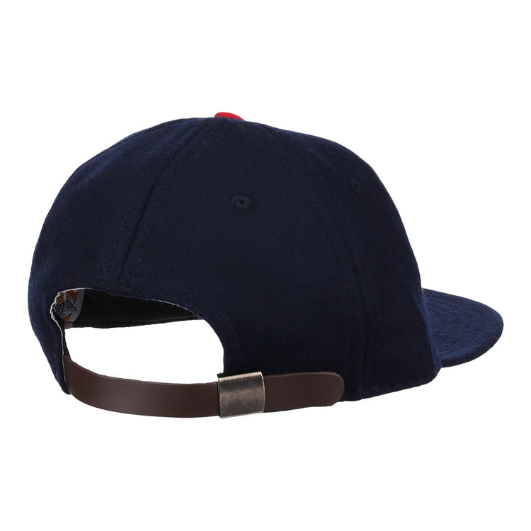 The Carta Blanca 1939 Vintage Ballcap by Ebbets Field Flannels is a navy blue cap, pictured from the back, with a brown adjustable strap and metal clasp, inspired by the 1939 Mexican League original.