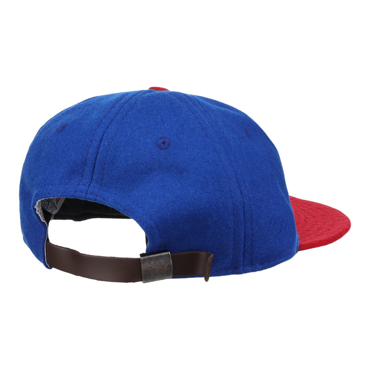 The Ebbets Field Flannels Miramar Yacht Club 1952 Vintage Ballcap is a genuine wool blue cap with a red brim, brown adjustable strap, and metal buckle—evoking the classic style of the original club ballcap.