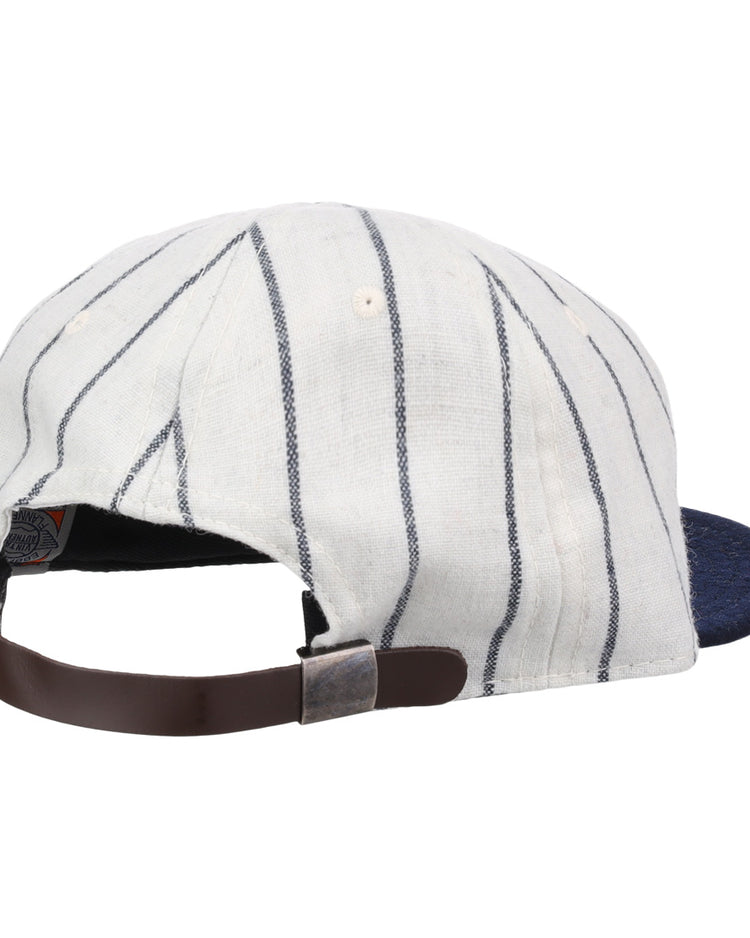 The Ebbets Field Flannels Vedado TC 1930 Vintage Ballcap features white fabric with thin navy stripes, a navy brim, and an adjustable brown strap with metal buckle, inspired by the Cuban National Amateur League classic.