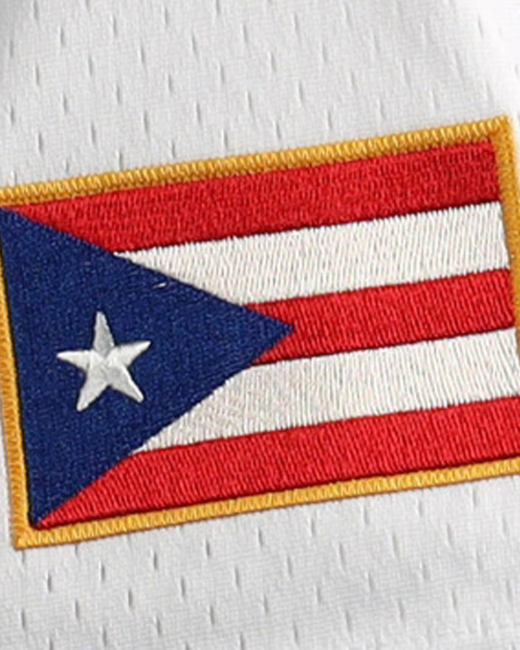 The image shows the flag of Puerto Rico, with red and white stripes, a blue triangle, a white star, and a gold border—details reminiscent of the EFF Roberto Clemente Santurce Cangrejeros Vintage Inspired NL Replica Button-Up Mesh Jersey.
