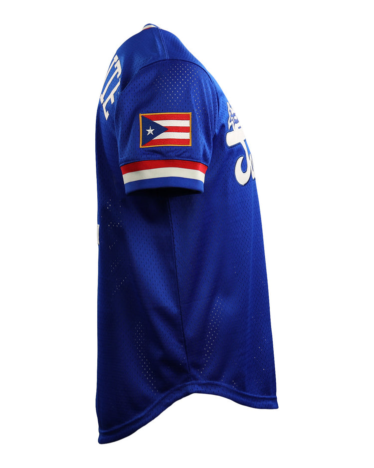 The EFF Roberto Clemente Santurce Cangrejeros Vintage Inspired NL Replica V-Neck Mesh Jersey in royal blue with white lettering and a Puerto Rican flag patch is shown on a mannequin from a side angle.
