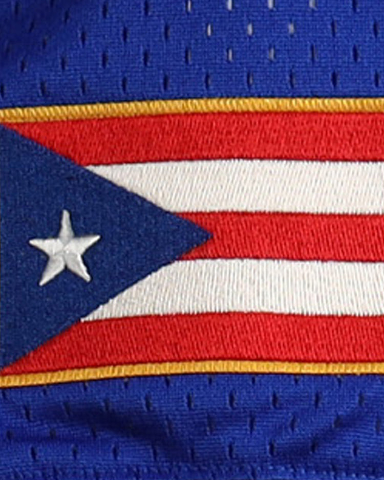 The image displays a patch of the Puerto Rican flag on blue fabric with a yellow border, reflecting EFFs Roberto Clemente Santurce Cangrejeros Vintage Inspired NL Replica V-Neck Mesh Jersey - Royal.