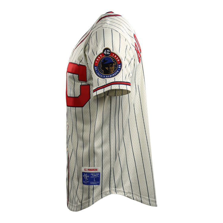 The EFF Jackie Robinson Kansas City Monarchs Vintage Inspired NL Replica Button-Up Mesh Jersey features white mesh with blue pinstripes, a red C, a #42 patch honoring Robinson, and a rectangular label on the hem.