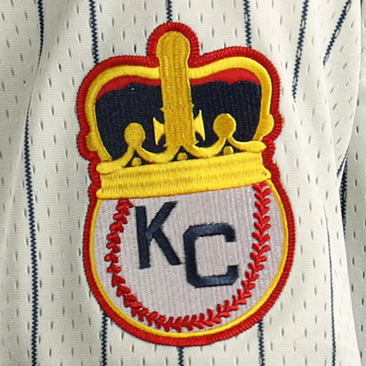 Embroidered patch featuring a gold crown atop a baseball with red stitching and KC letters, inspired by the Kansas City Monarchs, decorates this EFF Jackie Robinson Vintage Inspired NL Replica Button-Up Mesh Jersey.
