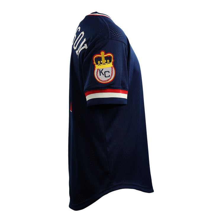 The EFF Jackie Robinson Kansas City Monarchs Vintage Inspired NL Replica V-Neck Mesh Jersey is navy blue with a crown and KC patch on the sleeve and partial white lettering on the back, inspired by classic mesh styles from Ebbets Field Flannels.