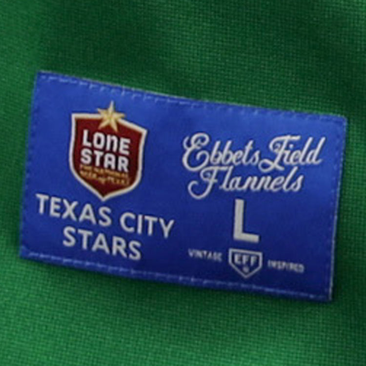 A blue fabric label on the green Texas City Stars EFF Lone Star Baseball Jersey by EFF reads Lone Star, Texas City Stars, EFF, L, and Vintage EFF Inspired with a star and shield logo—ideal for devoted baseball fans.