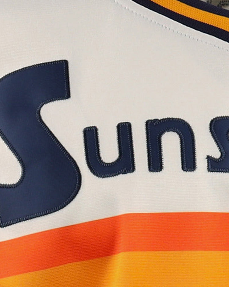 Close-up of the EFF Harlingen Suns Lone Star Baseball Jersey, featuring Suns in bold navy blue on white above orange and yellow stripes—a tribute to Texas baseball pride.