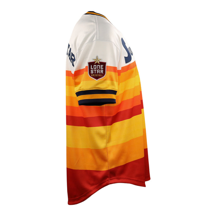 The Harlingen Suns EFF Lone Star Baseball Jersey by EFF features red, orange, yellow, and white horizontal stripes and a Lone Star patch on the sleeve, inspired by Texas baseball and the Harlingen Suns of the Lone Star League. Shown in side view.