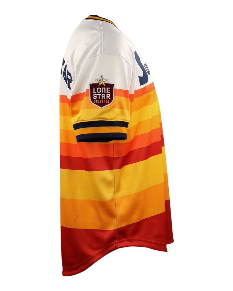 The Harlingen Suns EFF Lone Star Baseball Jersey by EFF features red, orange, yellow, and white horizontal stripes and a Lone Star patch on the sleeve, inspired by Texas baseball and the Harlingen Suns of the Lone Star League. Shown in side view.