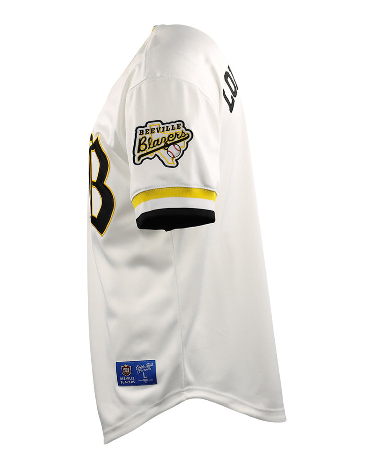 Side view of the EFF Beeville Blazers EFF Lone Star Baseball Jersey in white with black and yellow trim, featuring a Beeville Blazers patch on the sleeve, LOUD lettering on the upper arm, and a partially visible black front number.
