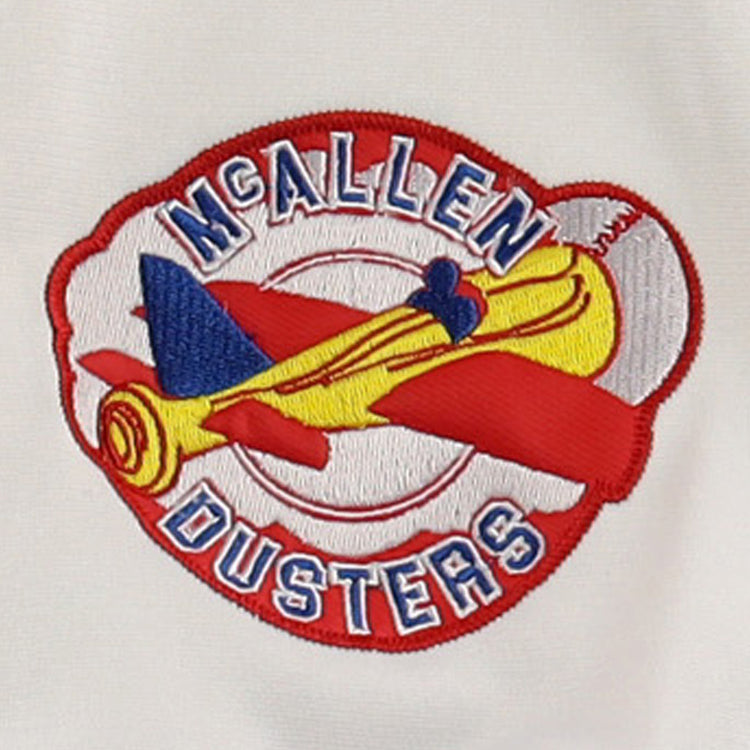 The EFF McAllen Dusters Lone Star Baseball Jersey features a yellow and red biplane embroidered with blue details and McALLEN DUSTERS in bold blue and white on a red and white background, celebrating local baseball pride.