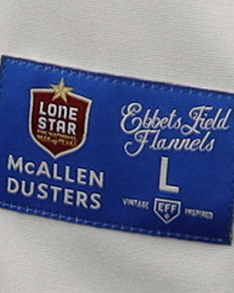 The McAllen Dusters EFF Lone Star Baseball Jersey by EFF features a blue and red label sewn onto white fabric—ideal for fans of classic baseball style.