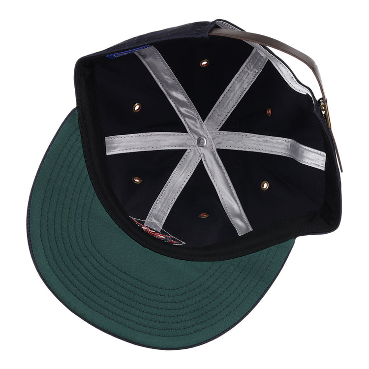 The image shows the inside of an EFF Columbus Red Birds cotton twill ballcap featuring a green brim, silver inner hatband strips, ventilation holes, and an adjustable brown leather strap with a metal buckle.