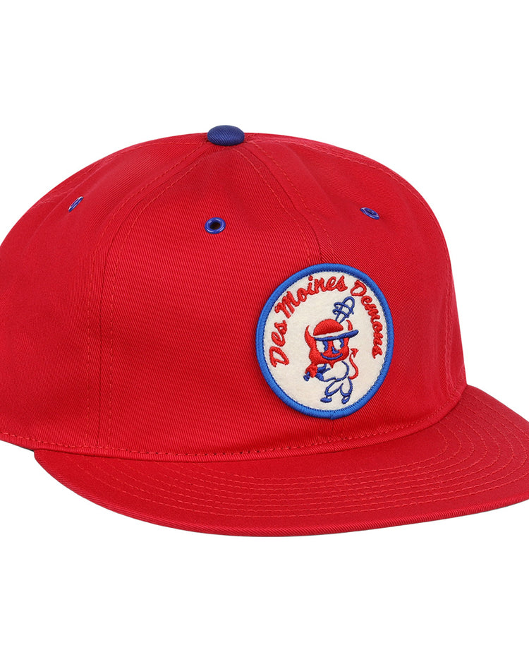 The EFF Des Moines Demons Cotton Twill Ballcap features a bright red design, round demons patch with cartoon graphic and Des Moines Demons text, plus blue eyelet and button accents—perfect for any summer series game.