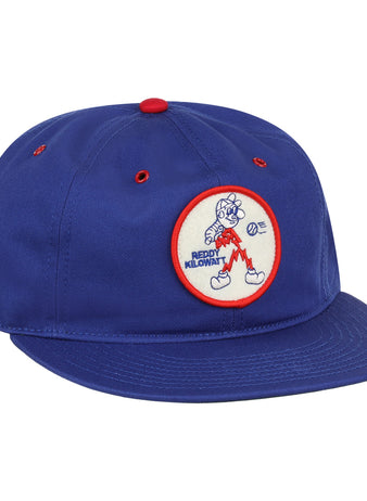The EFF Reddy Kilowatt Cotton Twill Ballcap is royal blue, featuring a front circular patch with Reddy Kilowatt running with lightning bolts and a red border.