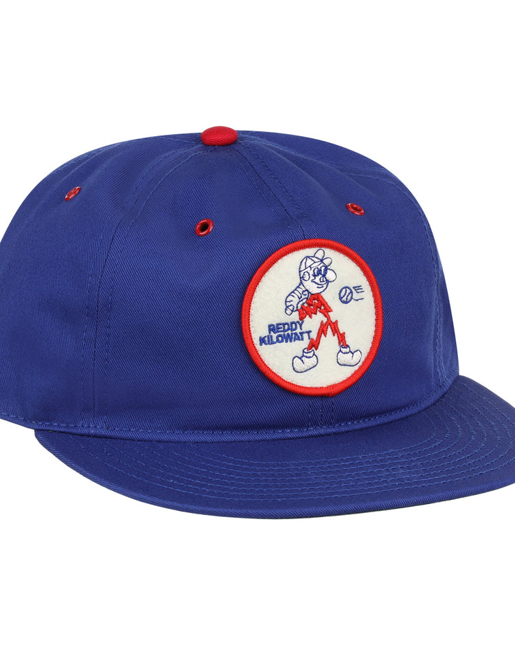 The EFF Reddy Kilowatt Cotton Twill Ballcap is royal blue, featuring a front circular patch with Reddy Kilowatt running with lightning bolts and a red border.